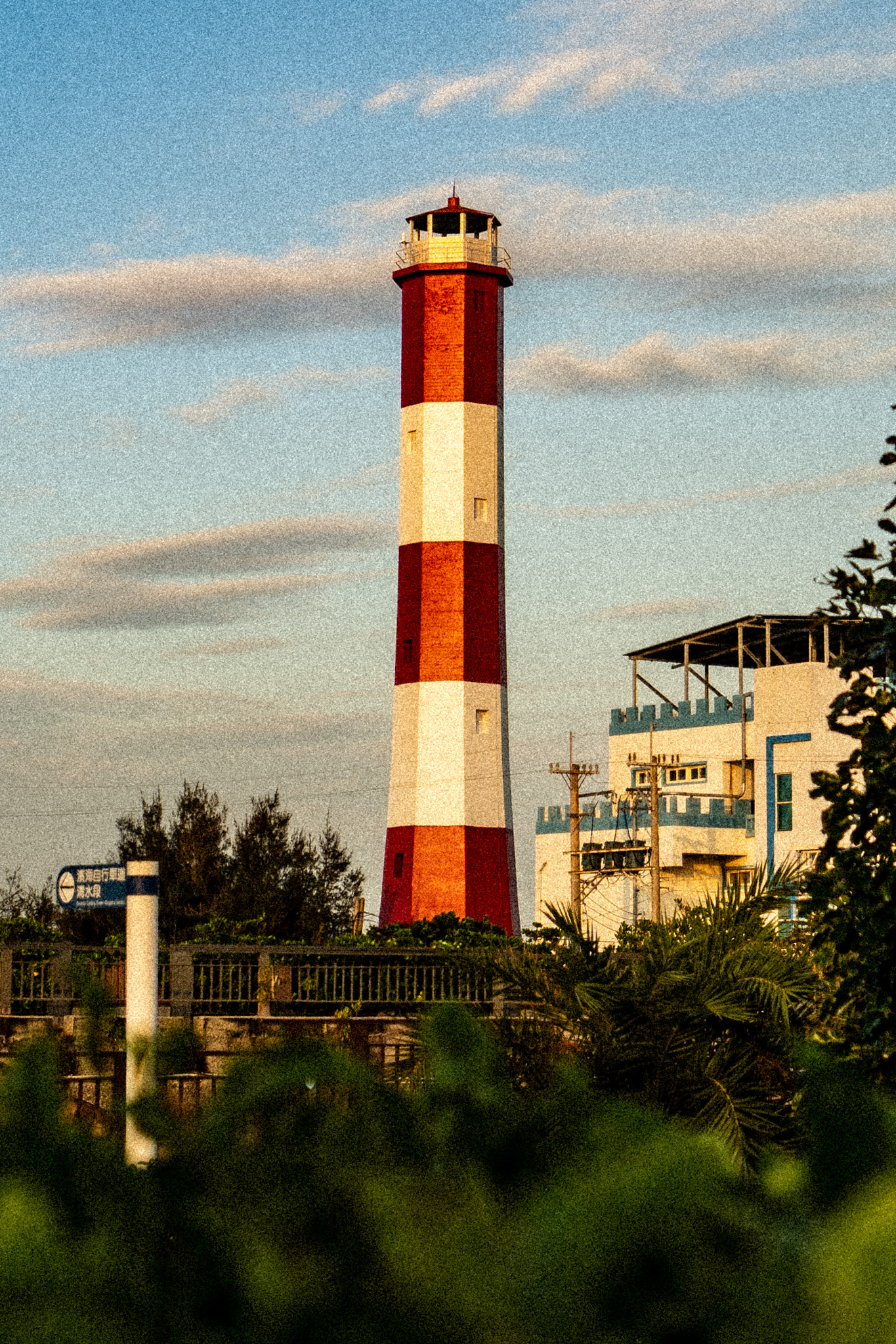 Red and white lighthouse under a blue sky in Taiwan